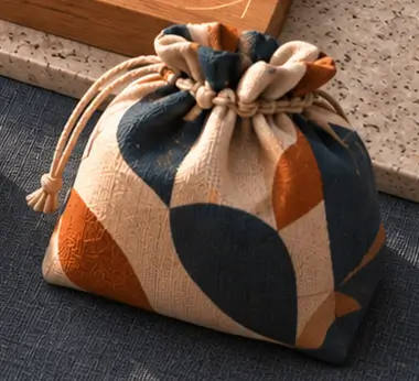 A patterned reward pouch at the fulfillment end of the workbench.