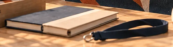 Patterned notebooks and collection pieces arranged along the worktable.
